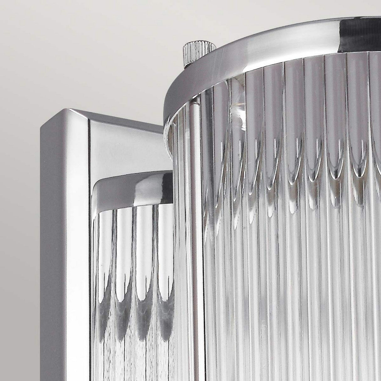 A close-up of the Paulson 1 Light Wall Light in chrome showcases its polished chrome frame and vertical, textured glass tube shades, making it suitable for an IP44 bathroom setting.