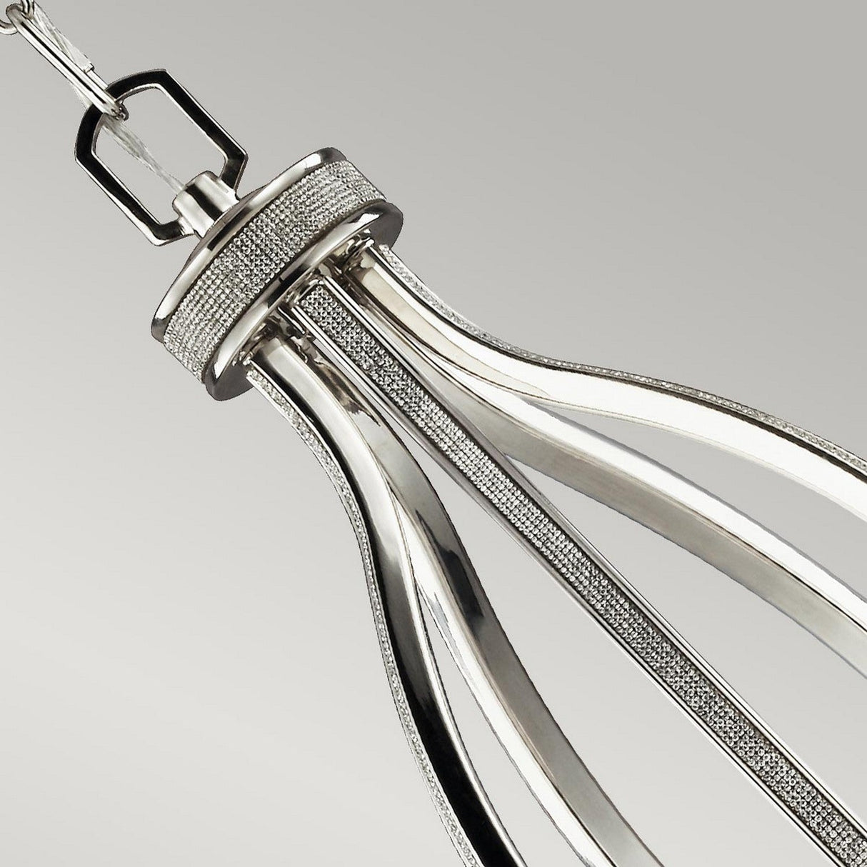 The Pave 5 Light Chandelier in polished nickel showcases a sophisticated, metallic design with sleek curves against a simple gray background. It features elegant, elongated loops and detailed textures reminiscent of a minimalist chandelier.