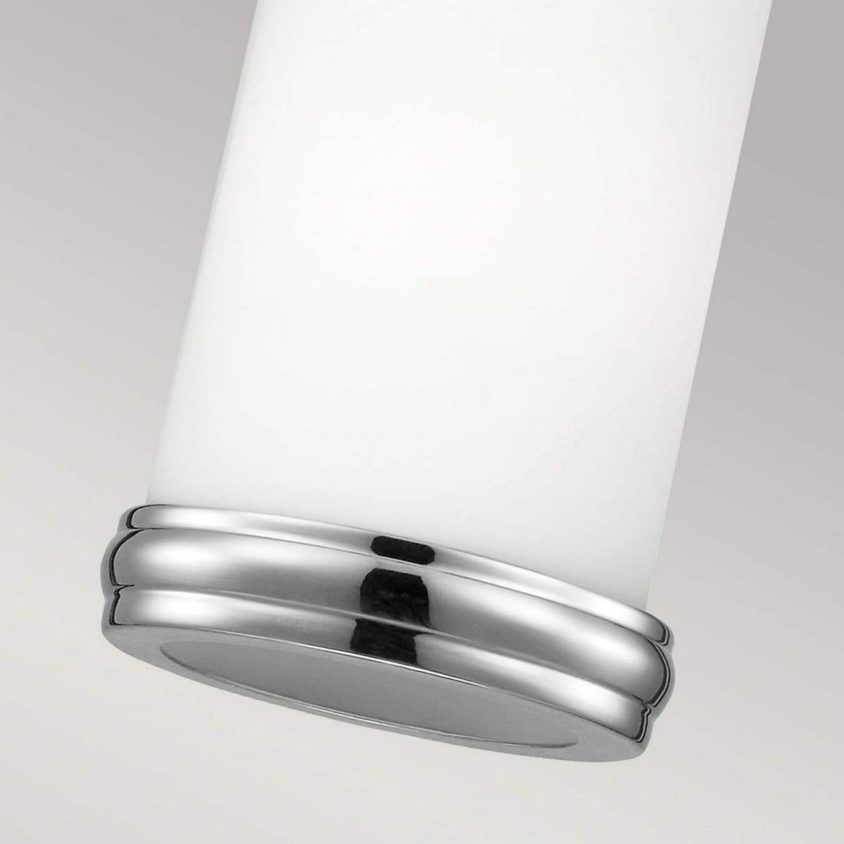 Detailed view of the Payne 1 Light Mini Pendant featuring a white opal glass body and polished chrome base set against a plain background. The smooth, reflective surface of the base beautifully contrasts with the matte texture of the cylinder.