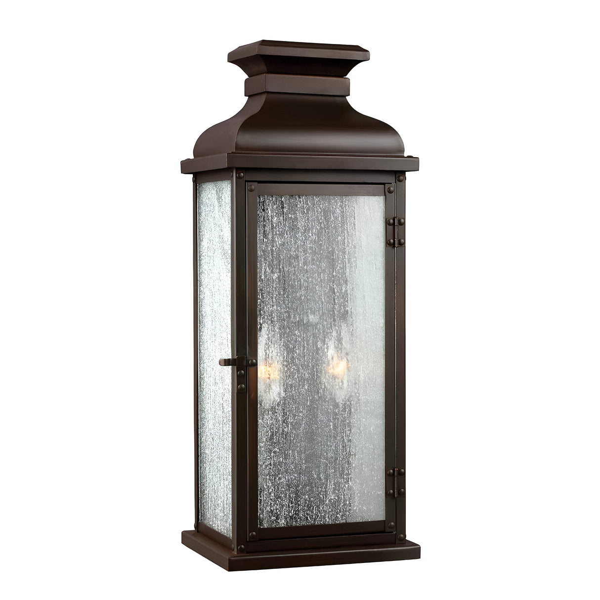 The Pediment 2 Light Outdoor Medium Wall Lantern in dark copper offers a tall, vintage-style design with seeded glass panels. Its rectangular construction and decorative top create a soft glow from the light inside.