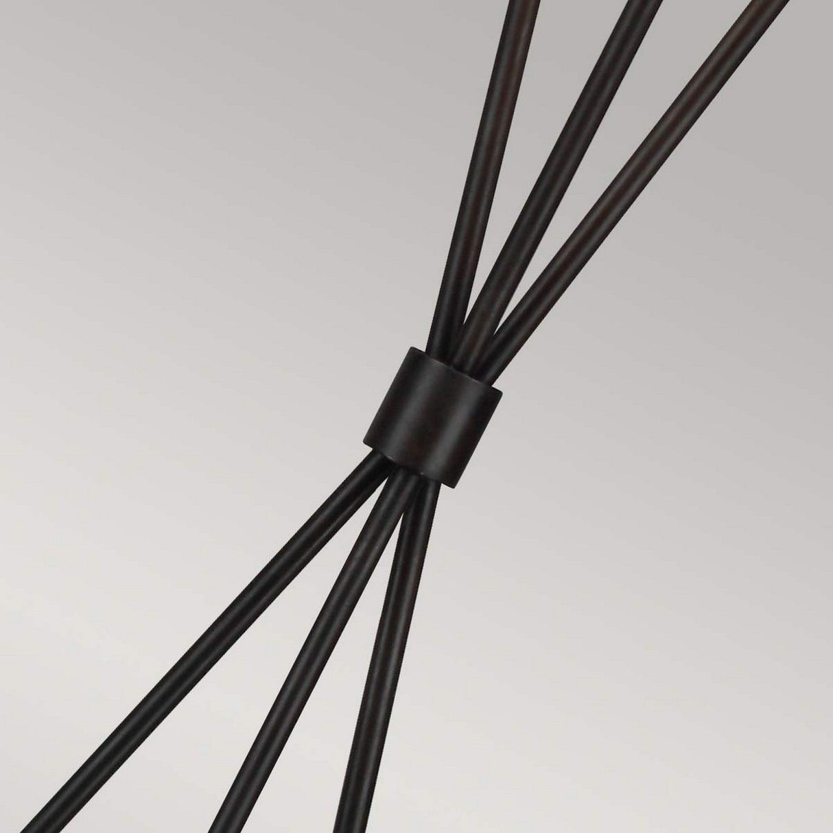 Close-up of several black metal rods converging at a central black cylindrical connector against a light gray background, capturing the essence of minimalist design in the Penny 1 Light Floor Lamp - Iron/White.
