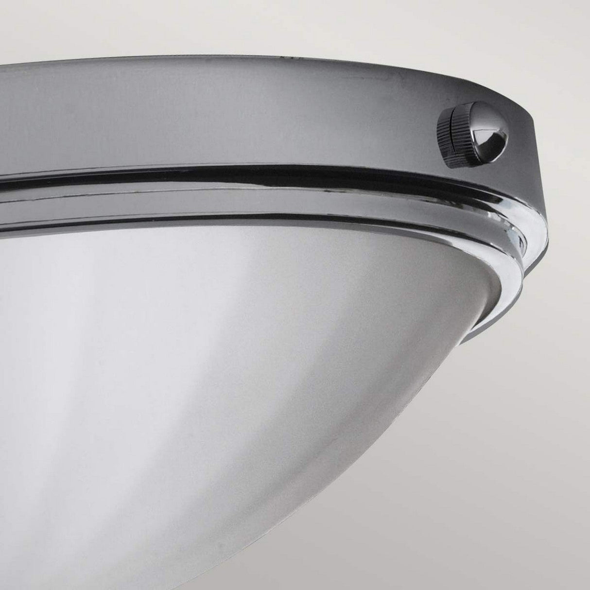 Close-up of the Perry 2 Light Flush in polished chrome, showcasing its modern metallic design with an opal-etched glass shade. The fixture boasts sleek, curved elements and a visible side screw, making it an ideal choice for enhancing any contemporary bathroom.