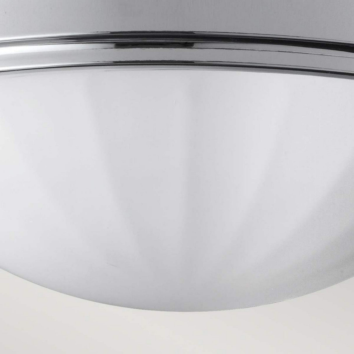 A close-up view of the Perry 2 Light Flush - Polished Chrome reveals its metallic, dome-shaped design featuring smooth, reflective surfaces and a minimalist aesthetic. The polished chrome finish paired with two parallel grooves near the top offers a sleek look that enhances any modern bathroom decor.