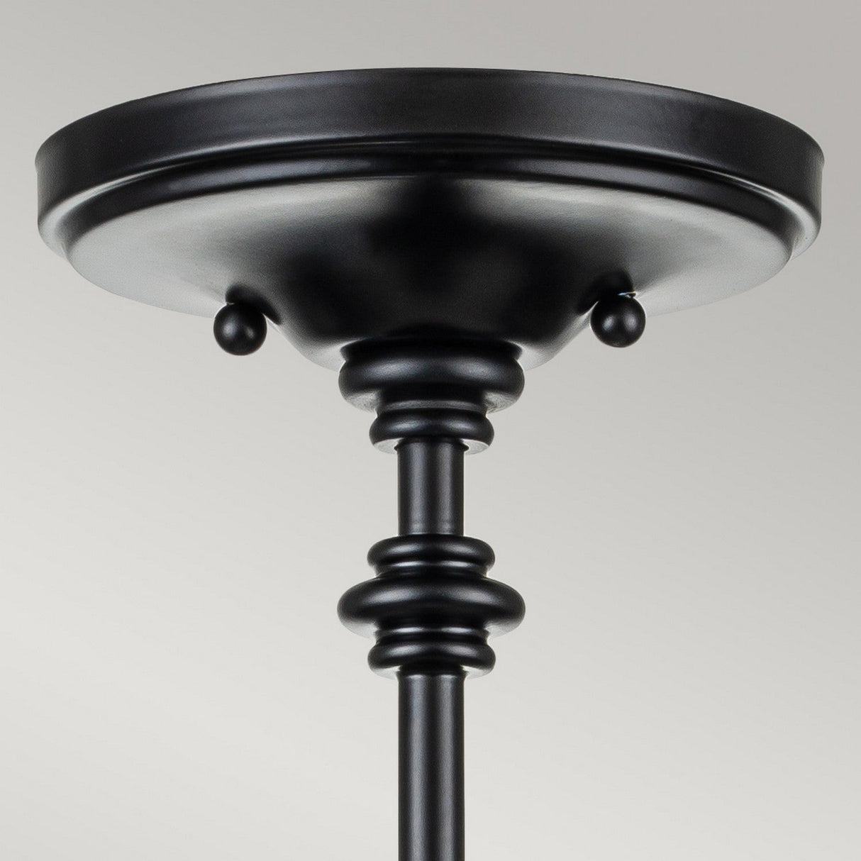 Here’s an updated description using the provided product data:
Close-up view of the Pickering Lane 3 Light Semi Flush in a black finish, showcasing a round design with decorative rods. It features a smooth matte surface and subtle ornamental details near the ceiling plate, complemented by seeded glass shades for added elegance.