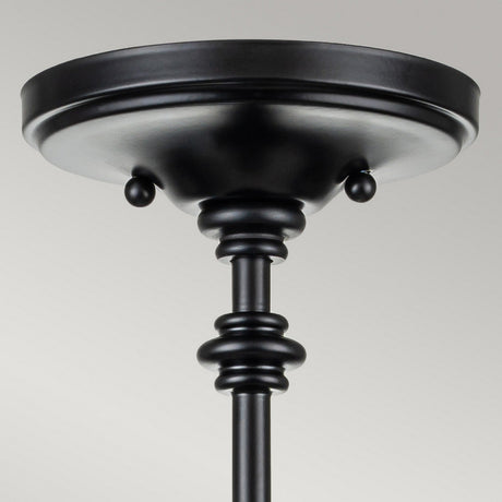 Here’s an updated description using the provided product data:
Close-up view of the Pickering Lane 3 Light Semi Flush in a black finish, showcasing a round design with decorative rods. It features a smooth matte surface and subtle ornamental details near the ceiling plate, complemented by seeded glass shades for added elegance.