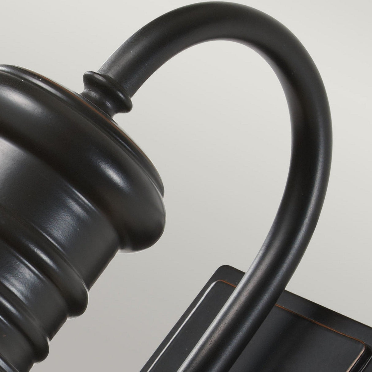 Close-up of a weather-resistant Redding Station 1 Light Outdoor Medium Wall Lantern in dark bronze, featuring a sleek design. This modern outdoor lantern is attached to a rectangular base, displaying elegant lines and a contemporary finish against a neutral background.