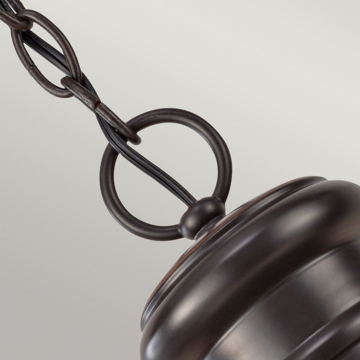 Close-up of the Redding Station 1 Light Outdoor Medium Chain Lantern in dark bronze, attached to a round fixture set against a light gray backdrop.