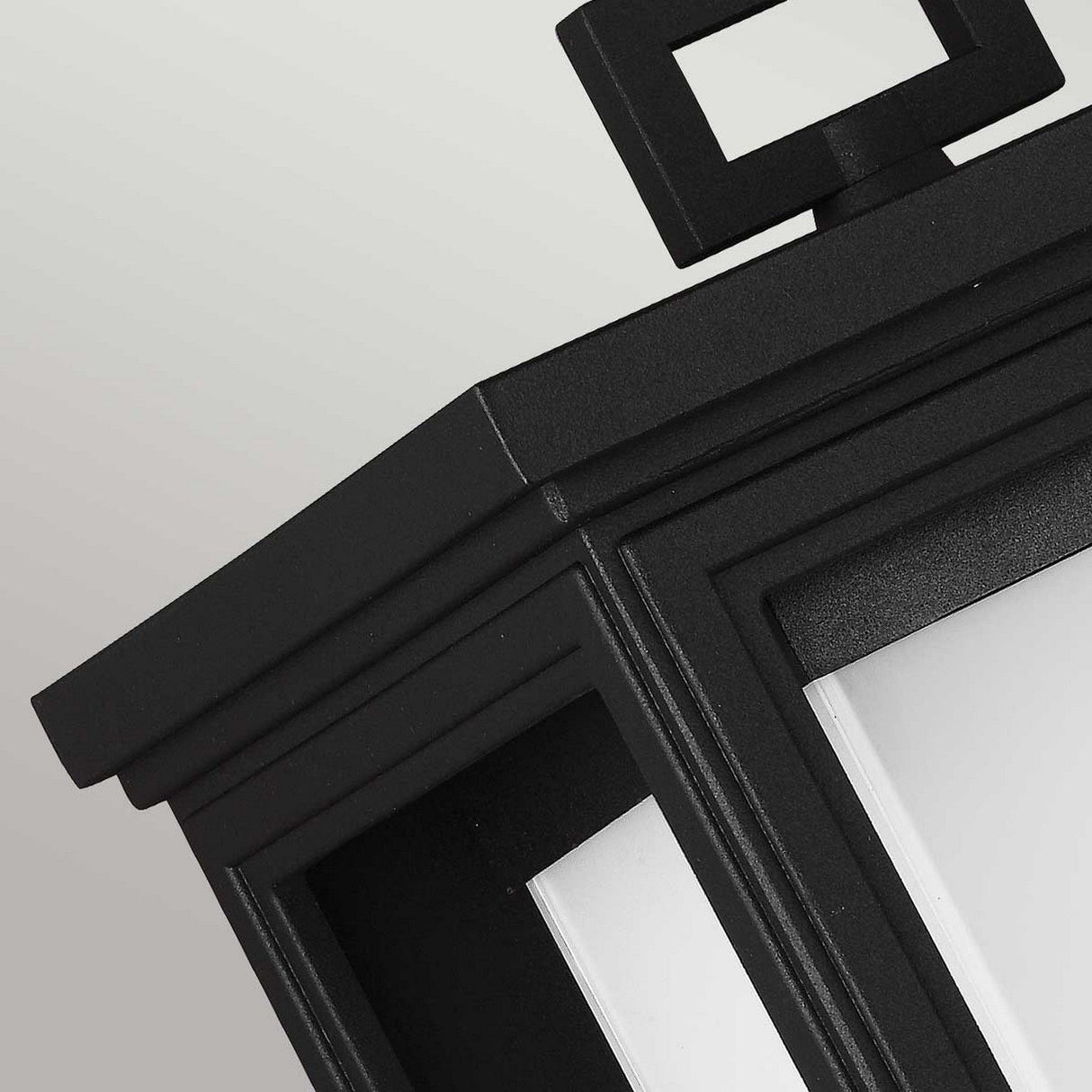 Close-up of the Roscoe 1 Light Outdoor Large Wall Lantern - Black, showcasing its weather-resistant construction and rectangular design with frosted glass panels, set against a neutral background.