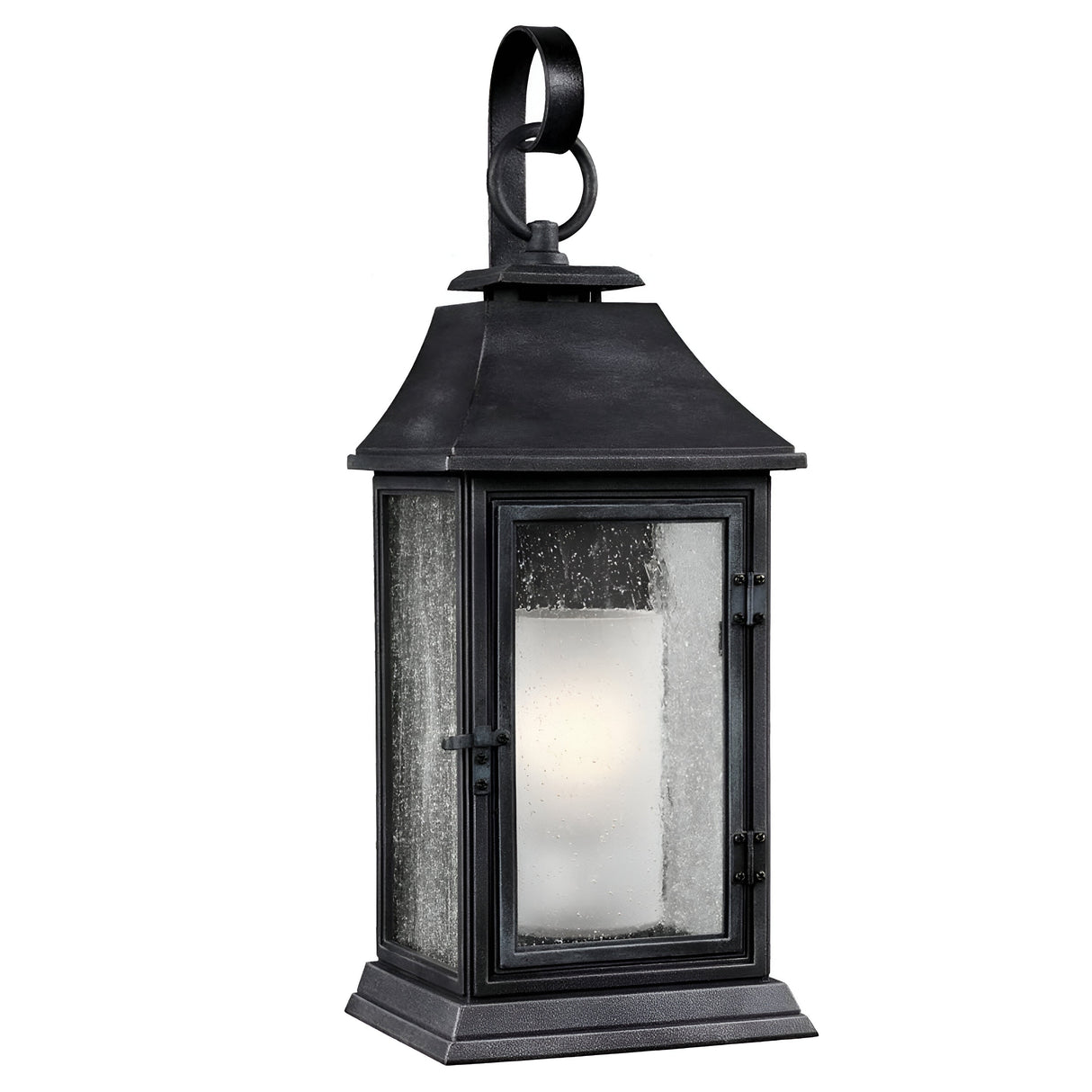 The Shepherd 1 Light Outdoor Large Wall Lantern in Dark Weathered Zinc hangs from a looped hook, showcasing its vintage style. This outdoor lantern features weather-resistant materials, an enclosed candle holder, a glass-paneled door, and a weathered finish that exudes both rustic charm and classic appeal.