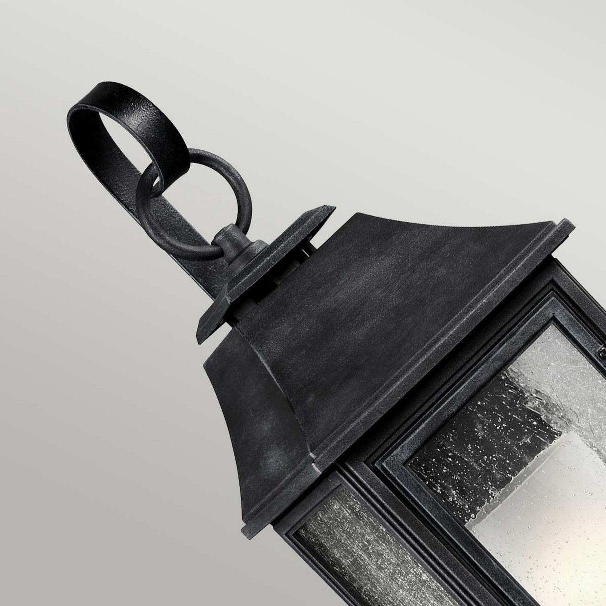 The Shepherd 1 Light Outdoor Large Wall Lantern in dark weathered zinc features a glass enclosure and a decorative metal loop for hanging. This weather-resistant lantern offers a vintage gas lantern appeal with its textured finish and casts a soft light, making it ideal for exterior decor. It is showcased against a neutral background.