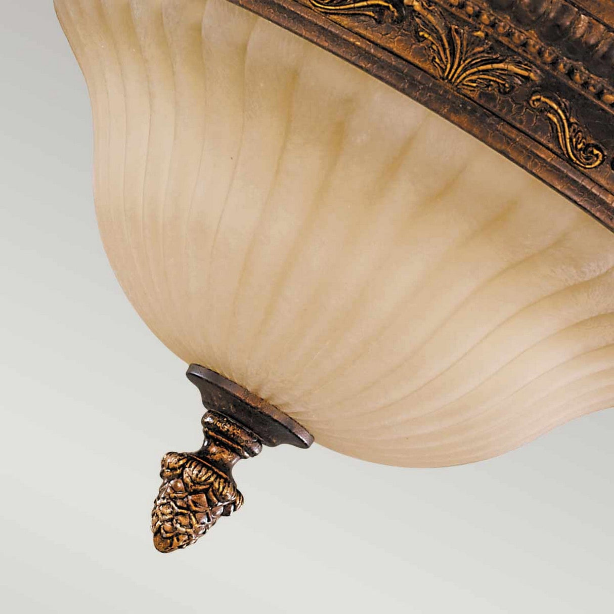 A close-up of the Sonoma Valley 2 Light Flush in classic French Country style, featuring a frosted glass shade with intricate bronze detailing and a decorative finial resembling an acorn. This elegant design exudes timeless charm reminiscent of Sonoma Valley aesthetics.