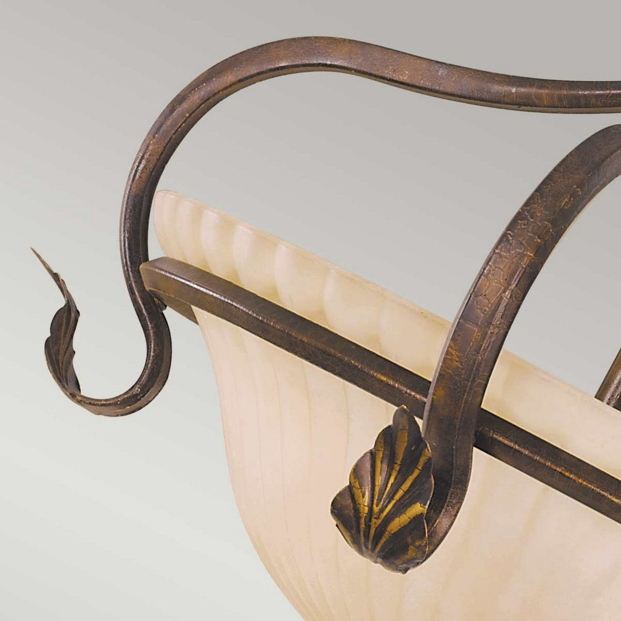 Close-up of the Sonoma Valley 3 Light Semi Flush in a stunning cream and bronze finish, showcasing a frosted glass bowl with intricate metalwork. It includes elegantly curved metal arms adorned with leaf-like accents, evoking the charm of French Country antiques for a sophisticated and classic design.