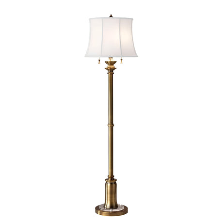 Introducing the Stateroom 2 Light Floor Lamp - Brass: a tall and elegant lighting solution featuring a brass-finished base and a white fabric lampshade. This sophisticated floor lamp showcases intricate detailing on the pole, complemented by its round base.