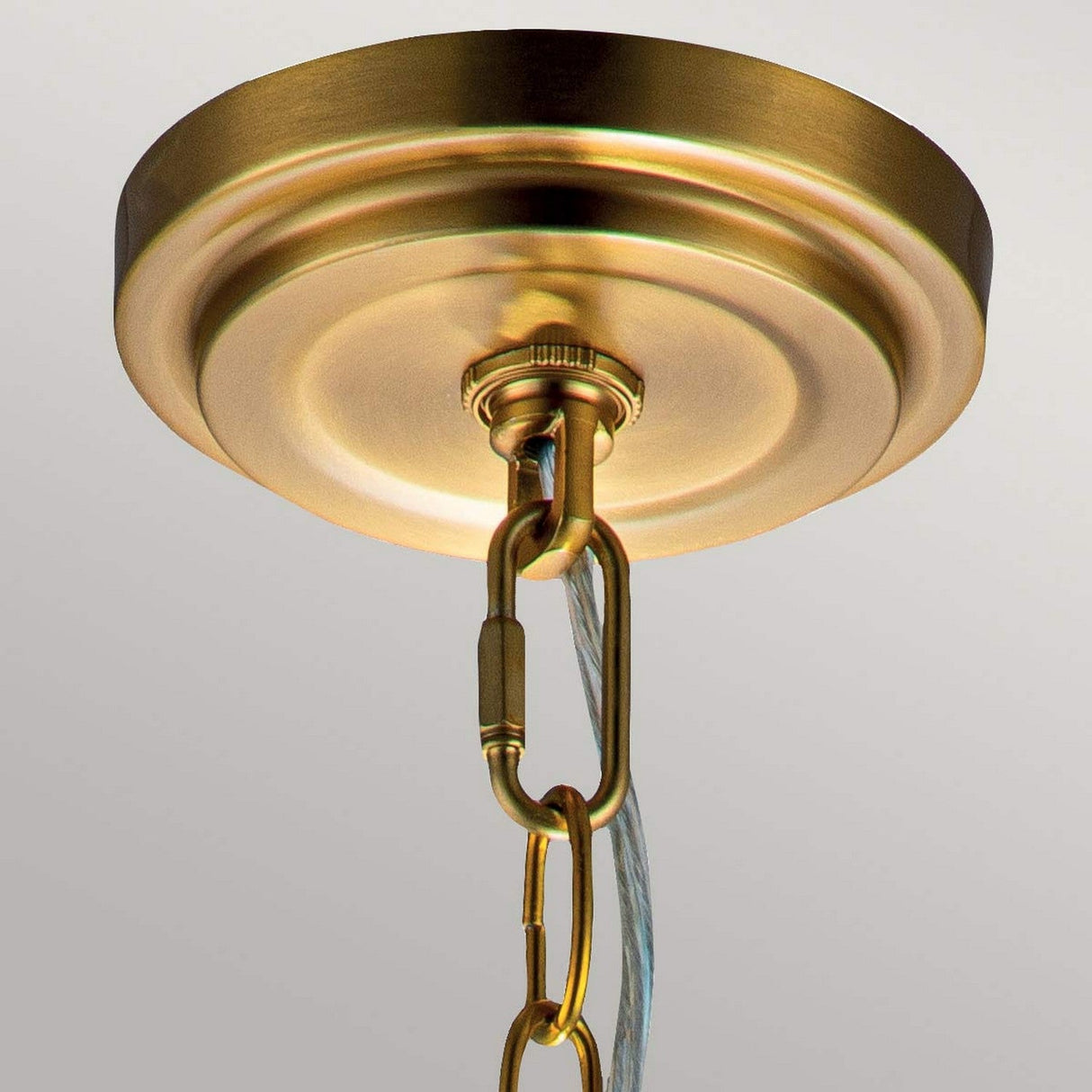 A close-up of the Tabby 1 Light Mini Pendant in burnished brass highlights its elegant sheen, embodying a pendant light design with minimalist appeal.