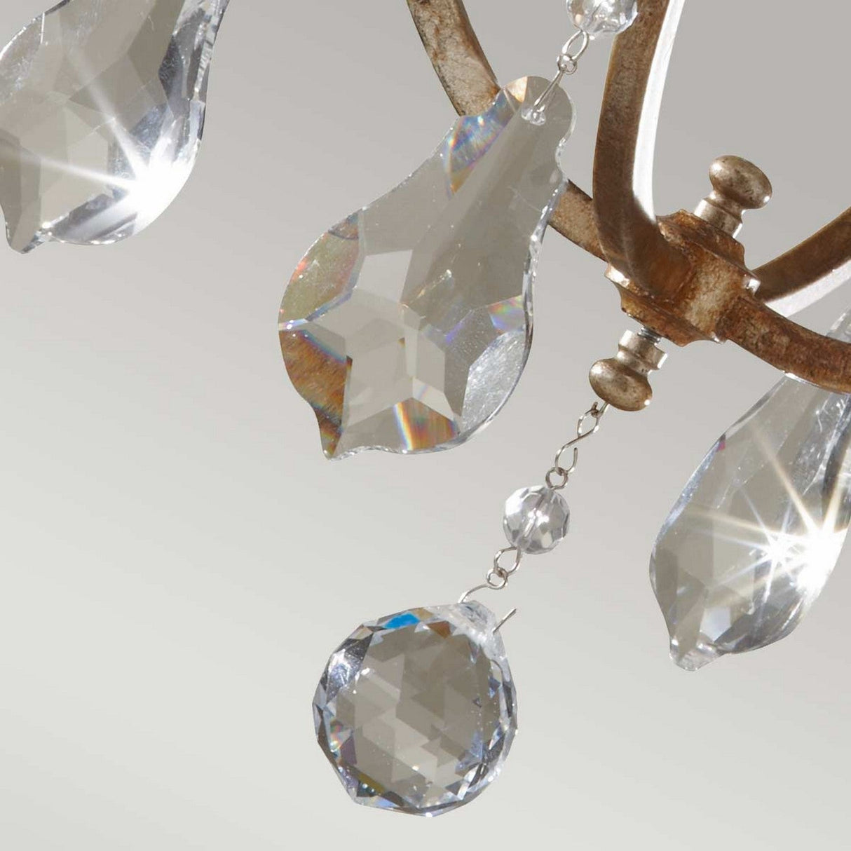 Close-up of the Valentina 1 Light Mini Pendant, featuring teardrop-shaped crystal pendants and a crystal bobeche suspended from an ornate, oxidized bronze frame. The crystals catch the light, creating a sparkling effect against a soft gray background.