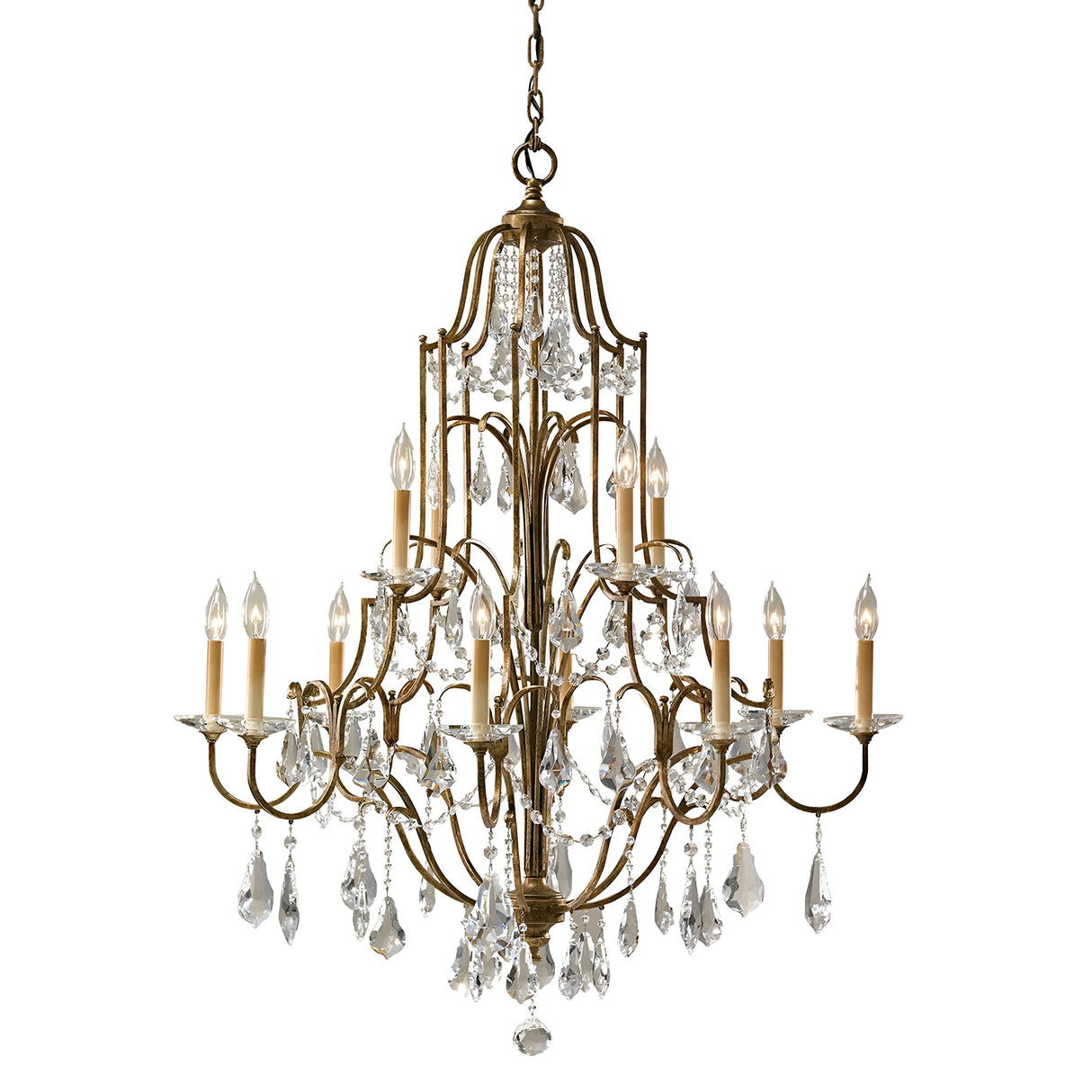 The Valentina 12 Light Chandelier - Oxidized Bronze showcases luxurious, antique-style craftsmanship with intricate oxidized bronze metalwork. Its design features multiple tiers adorned with crystal bobeches and twelve candle-shaped light bulbs, offering an elegant and classic ambiance.