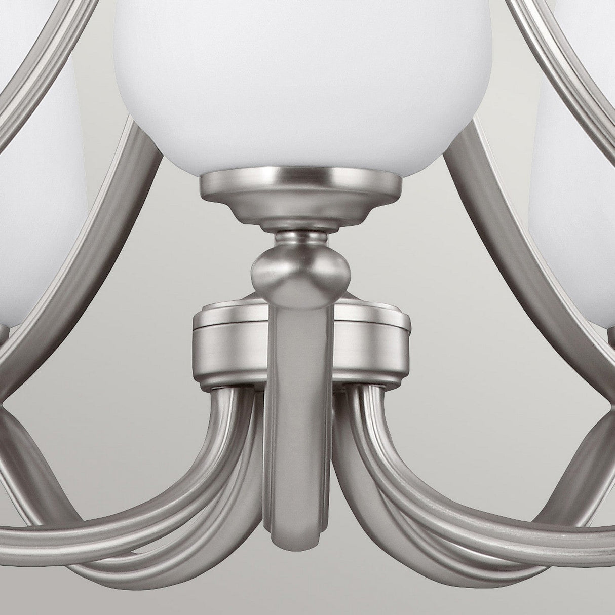 A close-up of the Vintner 5 Light Chandelier - Satin Nickel showcases its elegant, curved arms and opal etched glass shades set against a neutral background, blending modern design with classic style.