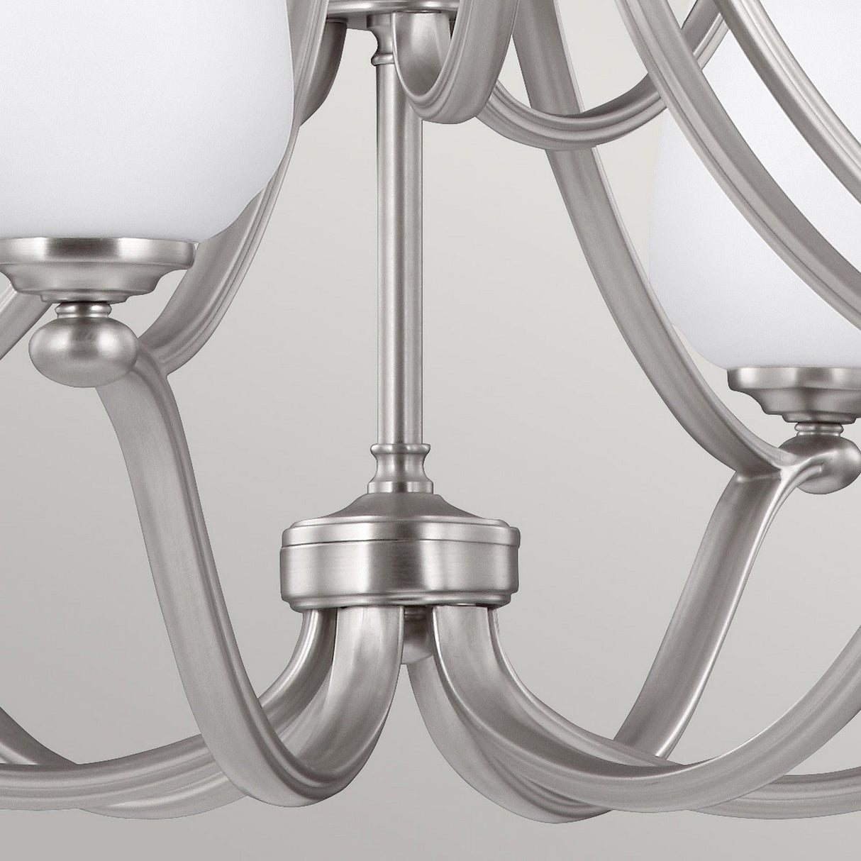 Close-up of the Vintner 9 Light Chandelier, featuring elegantly curved arms and opal etched glass shades. The fixture is finished in satin nickel, adding a touch of sophistication.