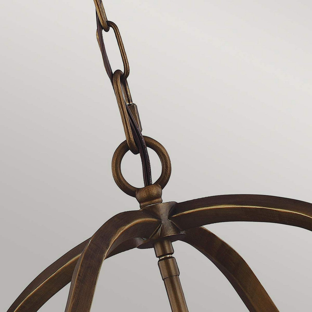 Close-up of the Yarmouth 6 Light Chandelier - Painted Aged Brass, showcasing its bronze-colored, curved arms suspended by a decorative chain. Its design captures the charm of traditional lanterns against a neutral background.