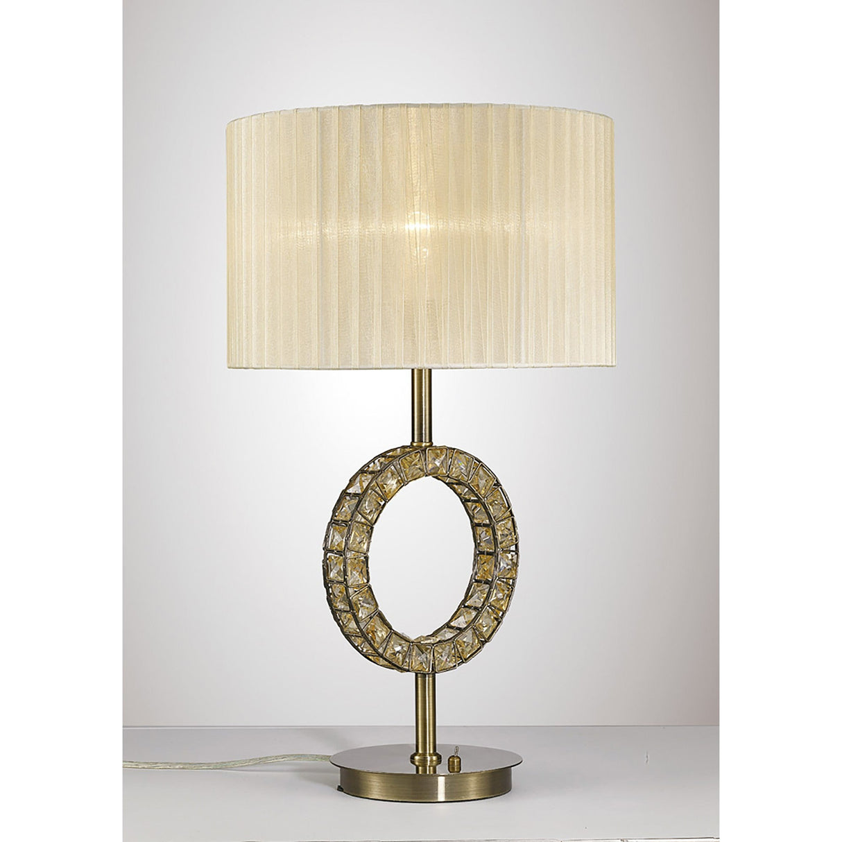 The Florence Round 1 Light Crystal Table Lamp features a brass base, a central crystal accent, and a large cream fabric shade, elegantly displayed on a white surface against a plain background.