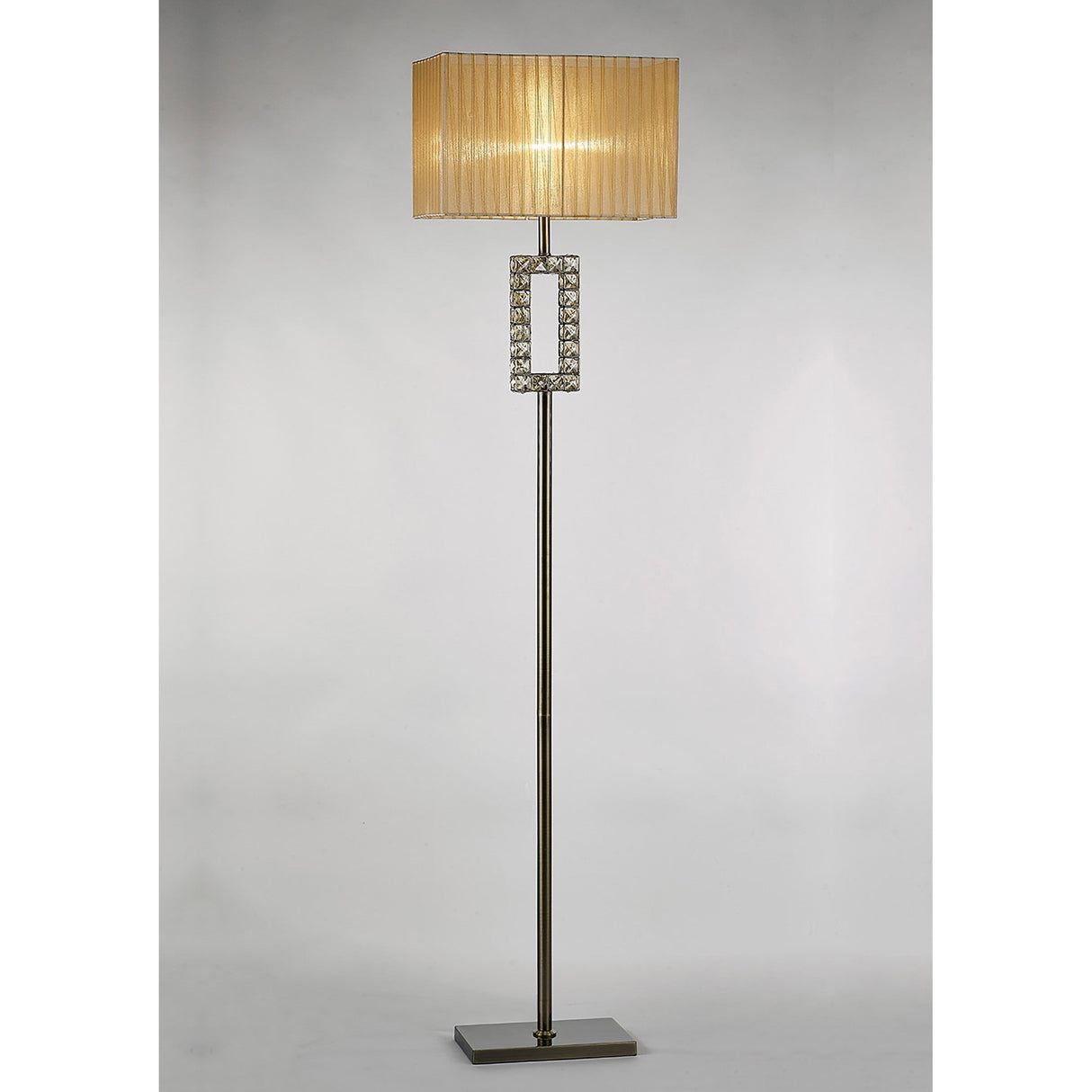 The Florence Rectangle 1 Light Crystal Floor Lamp features a slim brass stand, a cream rectangular shade, a crystal accent at the center, and a flat square base for modern elegance.