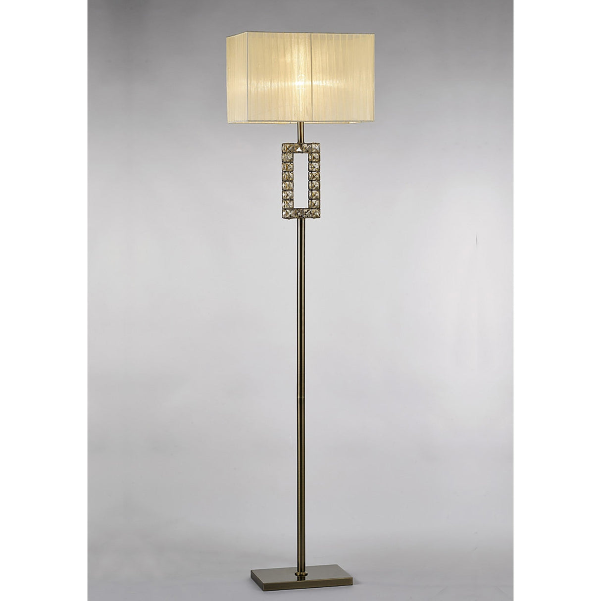 The Florence Rectangle 1 Light Crystal Floor Lamp features a brass slim stand, sparkling crystal accents below a cream rectangular shade, and a rectangular base for a modern touch.