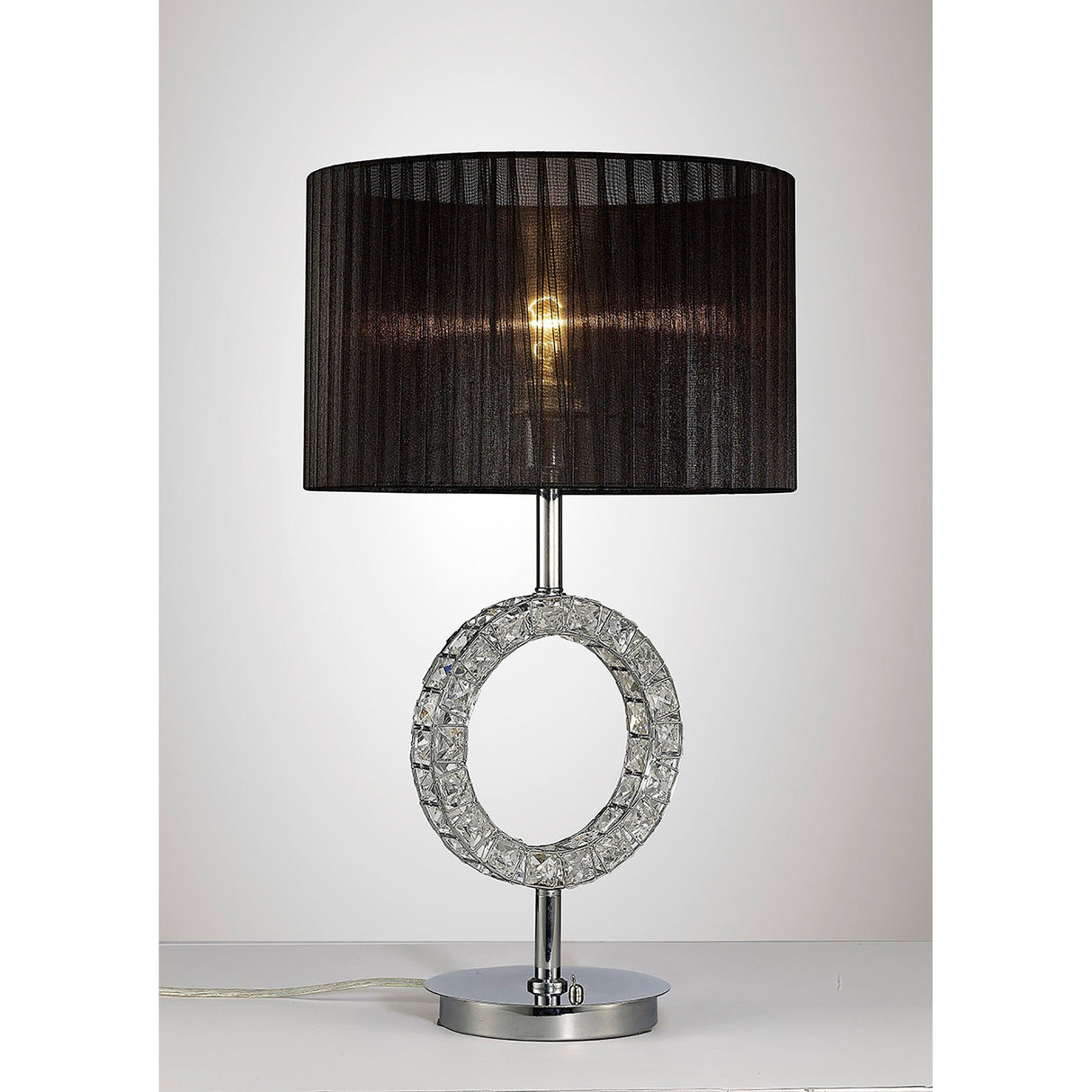 The Florence Round 1 Light Crystal Table Lamp features a sleek chrome base, a circular crystal ring on the stem, and a modern white shade, adding an elegant touch to any space.