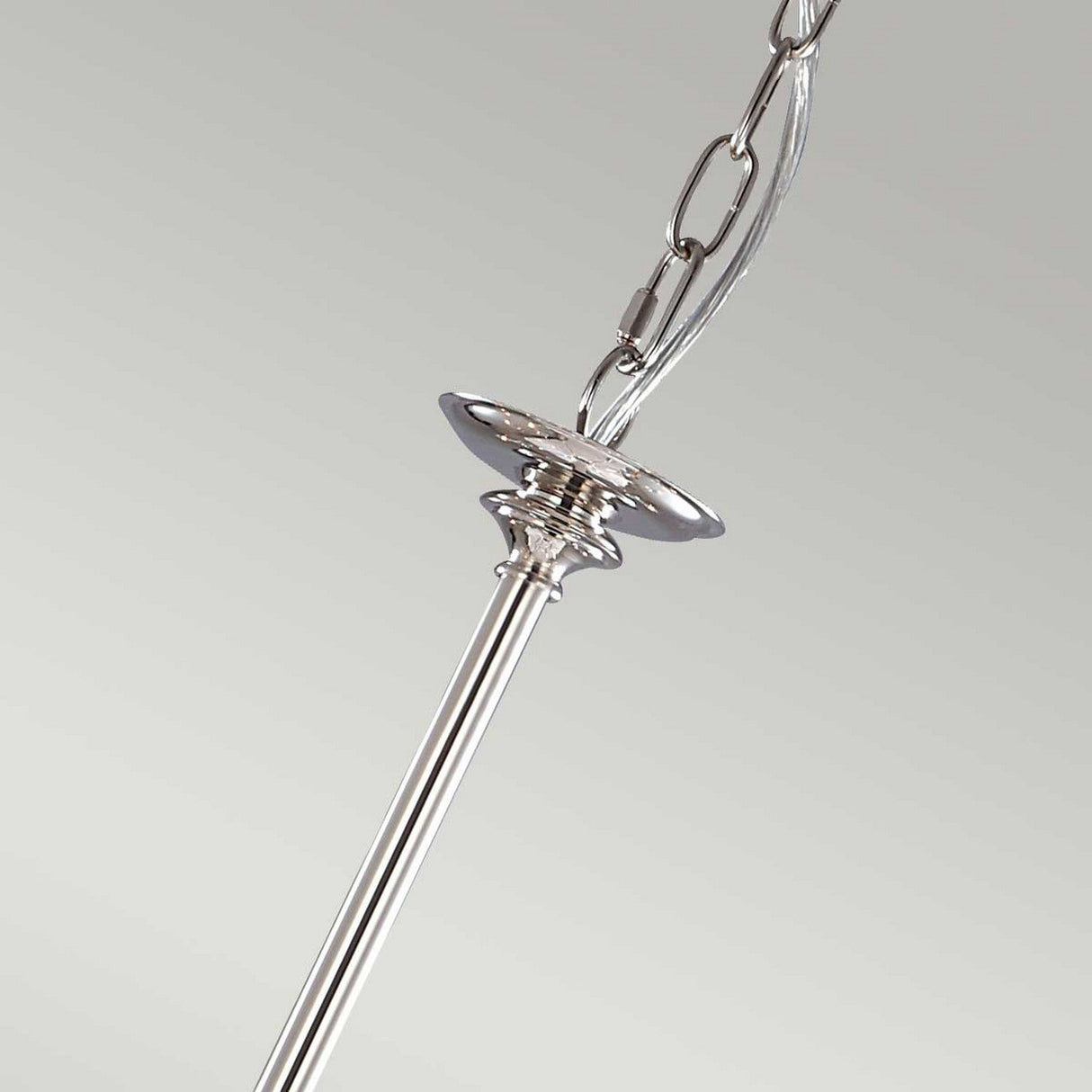 Close-up of a polished nickel chain connected to a metal rod with decorative flair, reminiscent of the elegance found in the Finsbury Park 9 Light Chandelier - Polished Nickel. The background is a plain, light gray color.