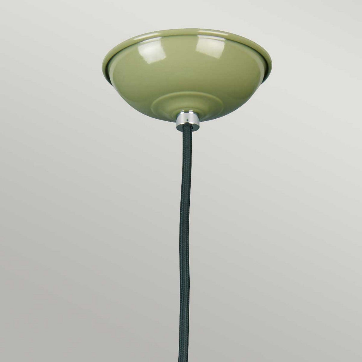 The Franklin Pendant Light - Green, featuring a glossy finish and black cord, exudes retro-inspired charm. This ceiling fixture is perfect for task lighting and elegantly contrasts against a plain, light gray background.