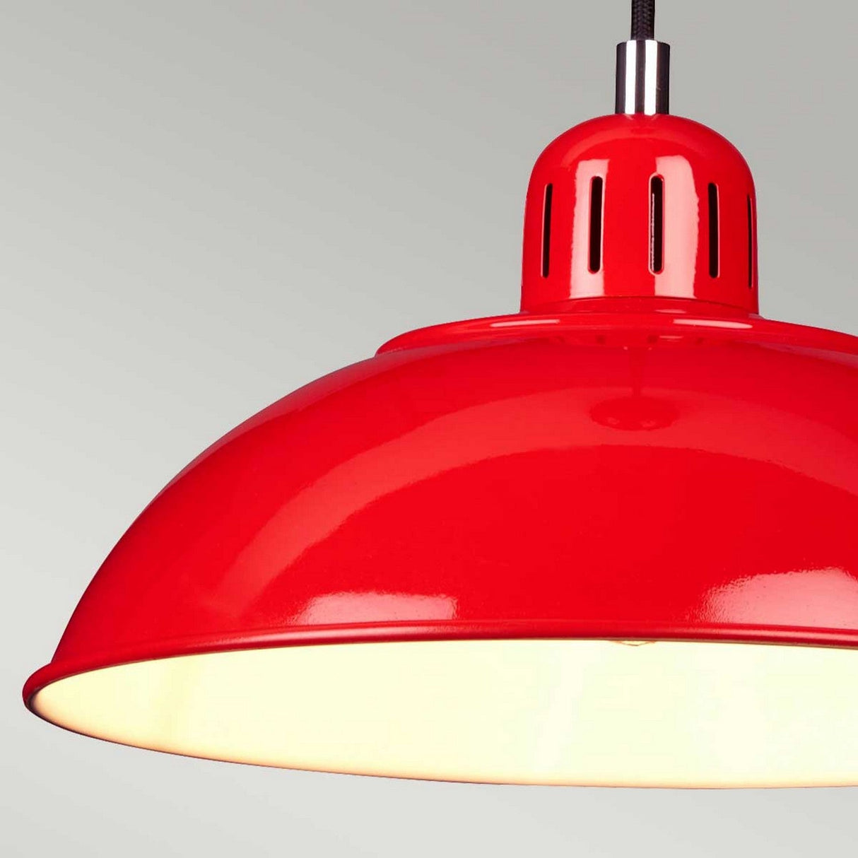 Close-up of the vibrant Franklin Pendant Light- Red against a light gray background. The lamp features a glossy finish, with small ventilation holes near the top, and provides warm white task lighting from below.