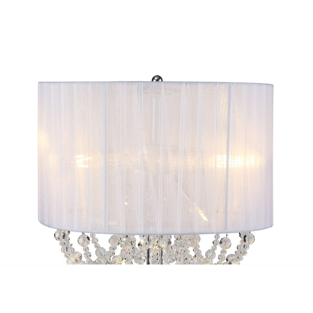 A close-up of the Freida 3 Light Crystal Table Lamp in chrome, featuring a white organza shade and decorative crystal accents, softly illuminated against a plain white background.