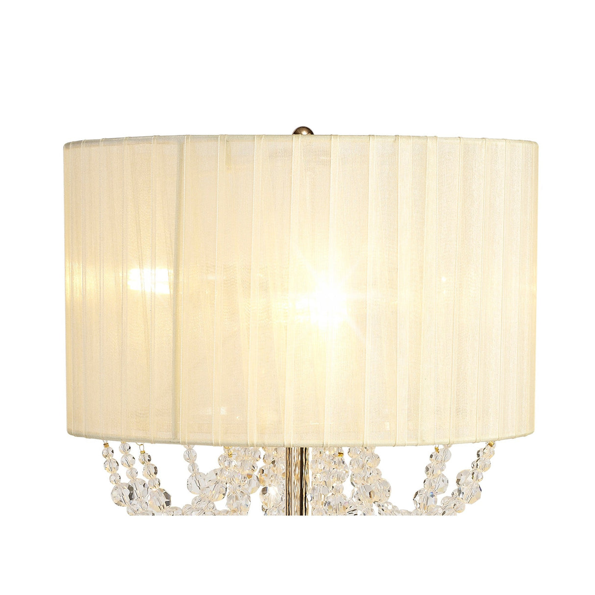 The Freida 3 Light Crystal Table Lamp features a gold base, cream pleated organza shade, and hanging crystal beads, casting a warm, inviting glow.