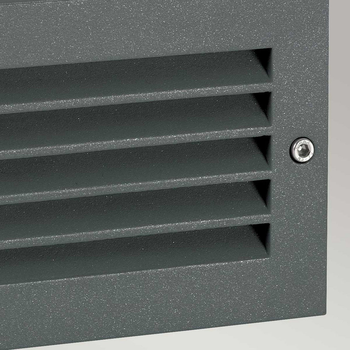 Close-up of the Grimstad LED Recessed Wall Light in a graphite finish, featuring horizontal slats and a visible screw in the top right corner, providing energy-efficient illumination.