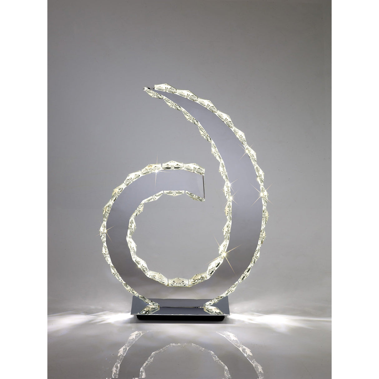 The Galaxy LED Crystal Table Lamp 12W 4000K in polished chrome features two intertwined illuminated spirals on a rectangular base, casting soft white light—ideal for modern interiors against a plain gray background.