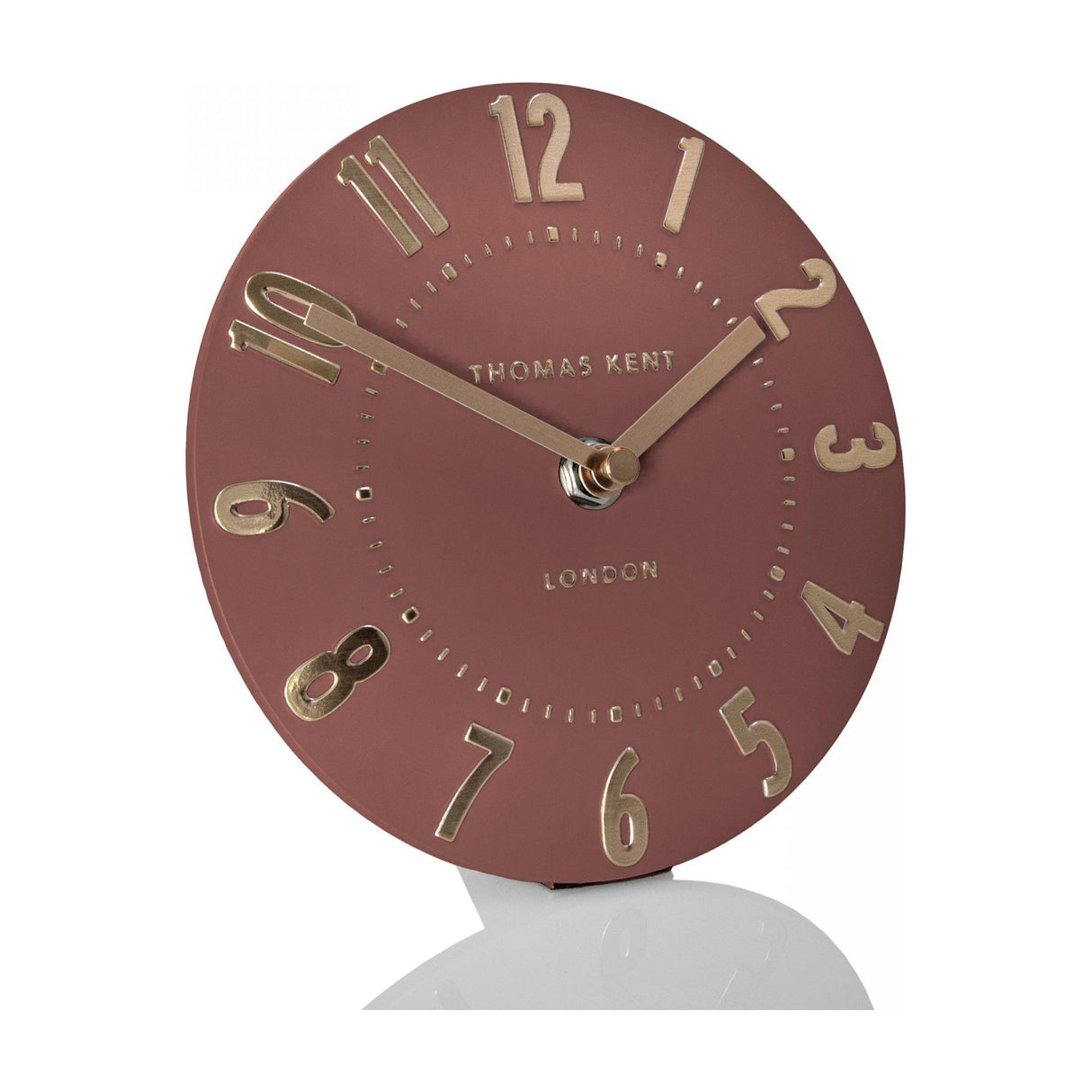 Thomas Kent Mulvorne 6 inch mantel clock with a round auburn dial, raised gold 3D Arabic numerals and slim metal hands on a plain background.