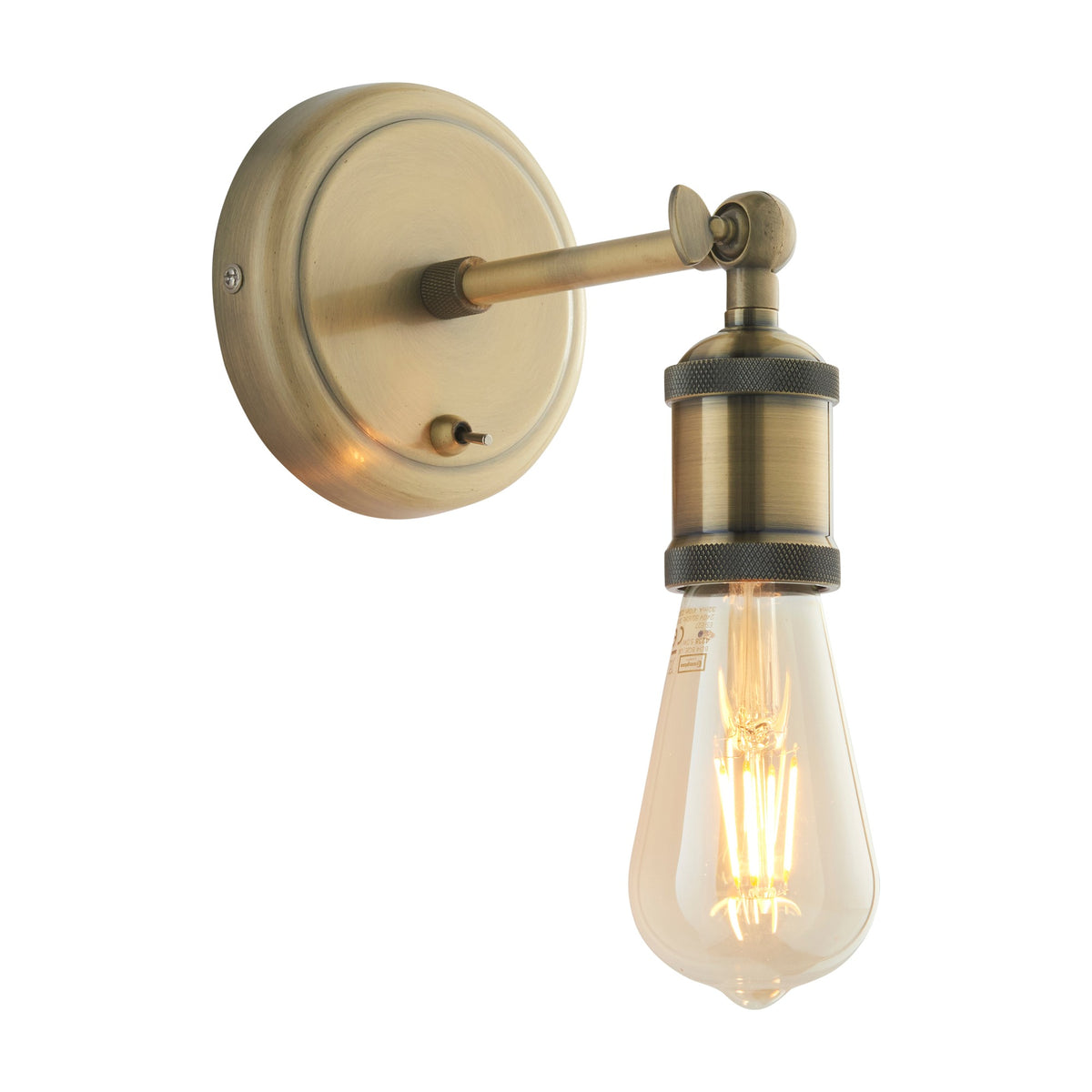 Gallery Direct Halvane Bare Bulb Wall Light in antique brass with round backplate, knuckle-jointed arm, toggle switch and exposed filament bulb.