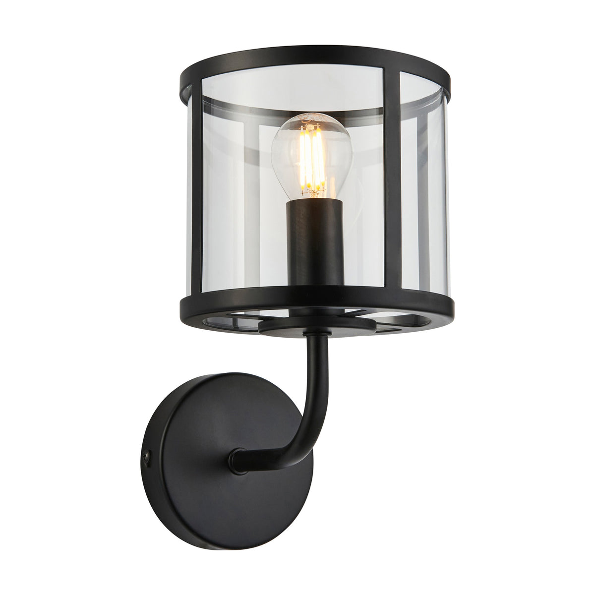 Gallery Direct Hoplora Wall Light in matt black with a steel cage, clear glass drum shade, curved arm, round backplate and exposed filament bulb.