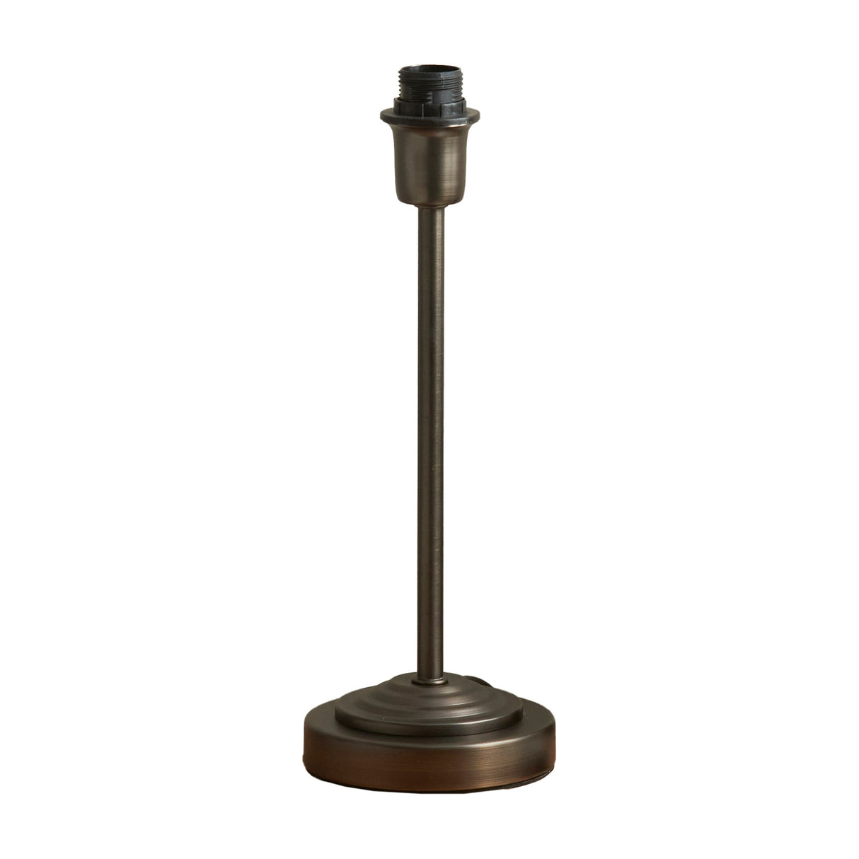 Gallery Direct Riselle Table Lamp Base in antique bronze steel with a slim stem, stepped round foot and screw-fit E27 bulb holder, no shade.