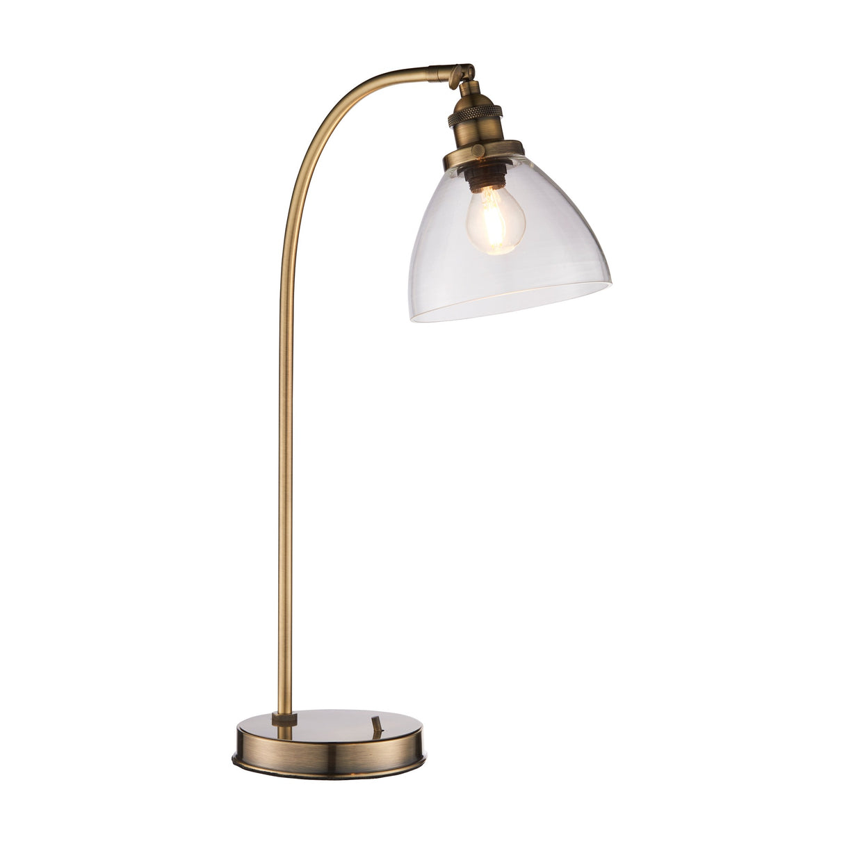 Sarwen Table Lamp by Gallery Direct with a curved antique brass arm, weighted round base and clear glass dome shade housing an E27 filament bulb.