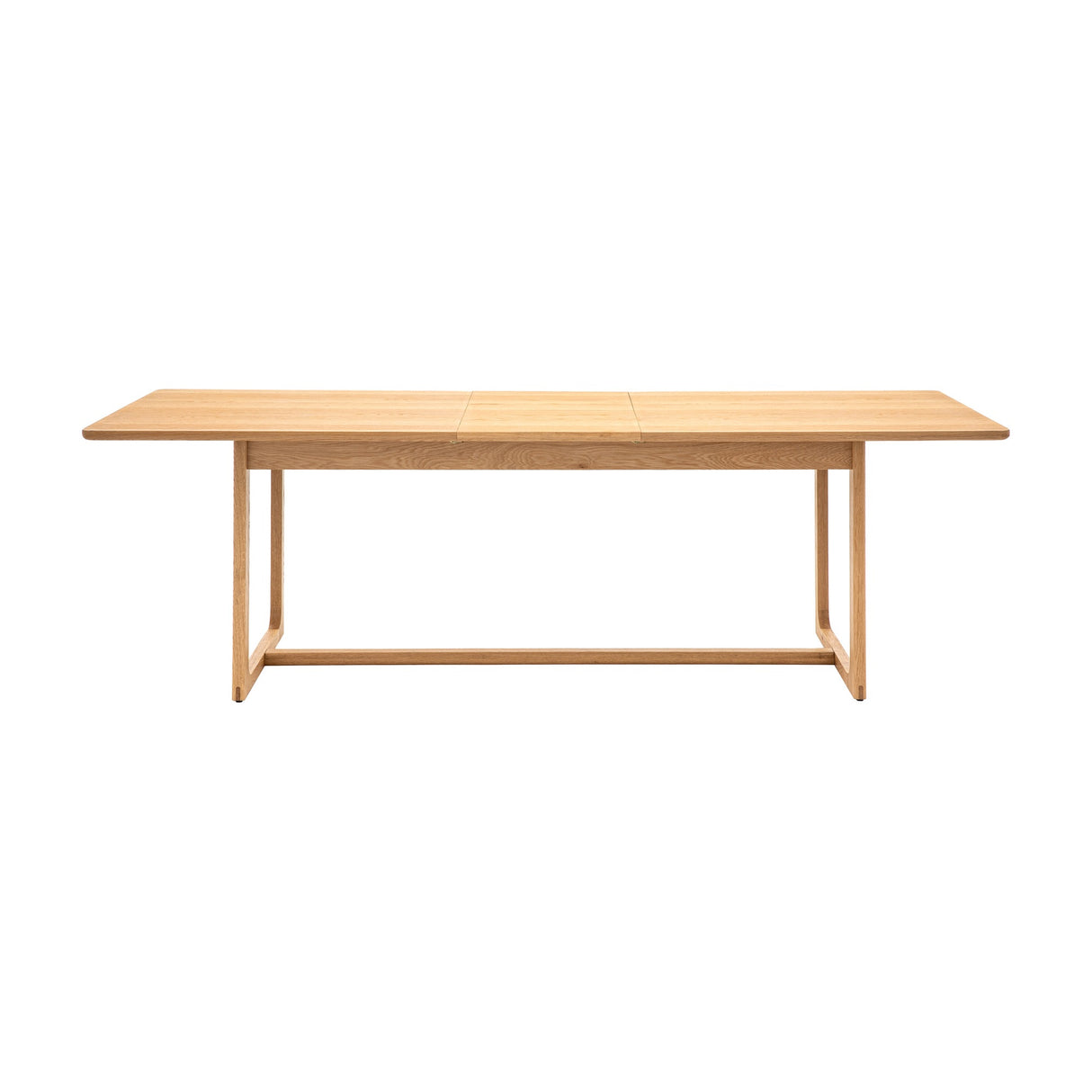 Gallery Direct Craft Extending Dining Table in natural oak, rectangular top with rounded corners and sculptural sled-style frame, shown on a white background.