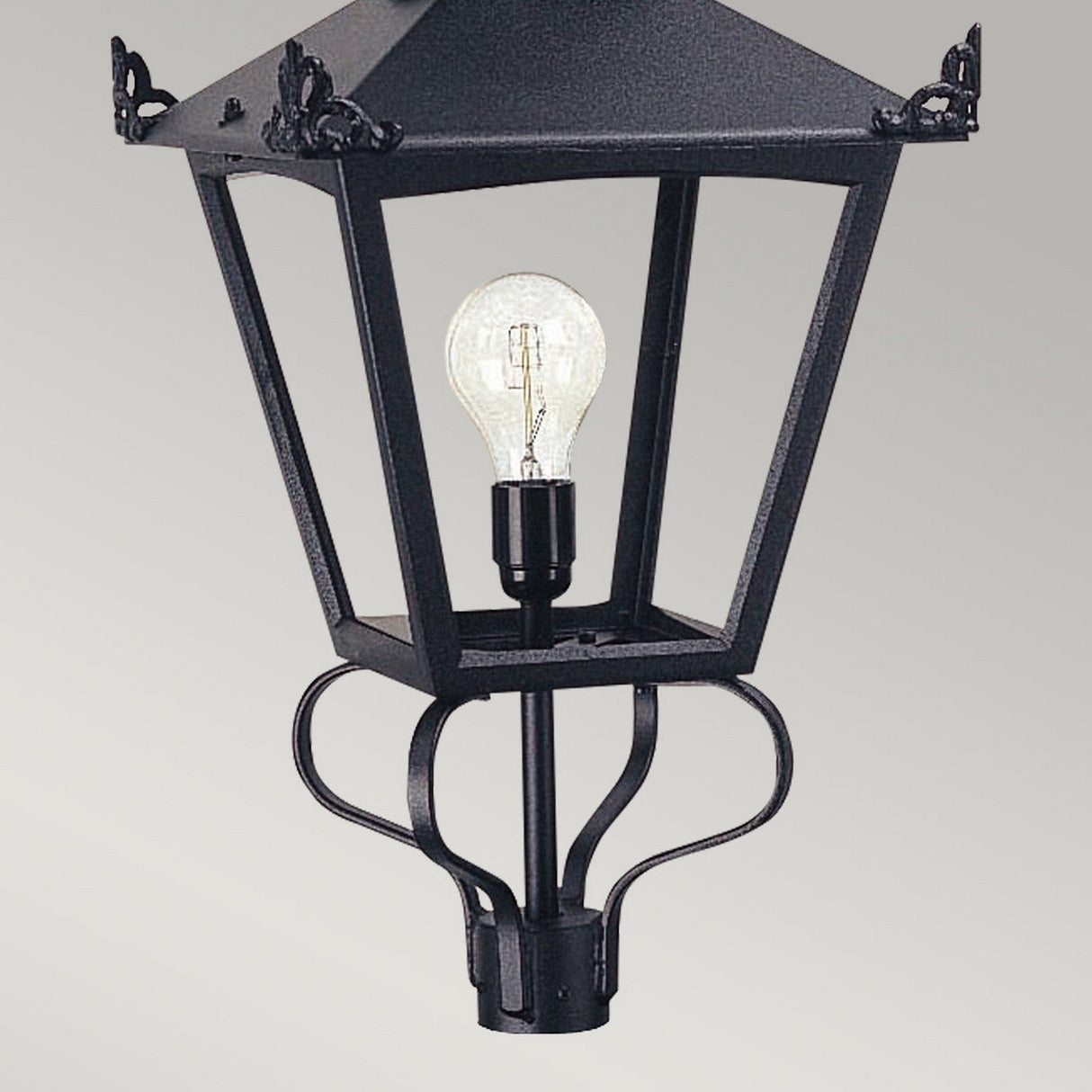 Introducing the Grampian 1 Light Lamp Head in Black, this Victorian-style outdoor lamp showcases an elegant cast aluminum design with a clear glass enclosure and an exposed bulb. Against a simple gray background, it features intricate decorative details at the corners that enhance its aesthetic appeal.