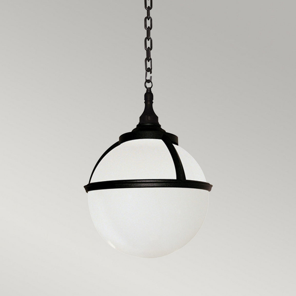 The Glenbeigh 1 Light Outdoor Chain Pendant features a modern spherical design with a frosted glass shade and a corrosion-proof black polymer frame. It is suspended by a black chain against a simple gray background. This IP44-rated outdoor light pendant blends style with durability for any environment.