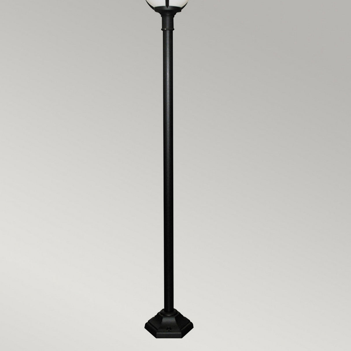 Set against a plain gray background, the Glenbeigh 1 Light Lamp Post in black features a straightforward design with a hexagonal base and corrosion-resistant finish. Its partially visible lantern highlights the elegance of outdoor lighting.