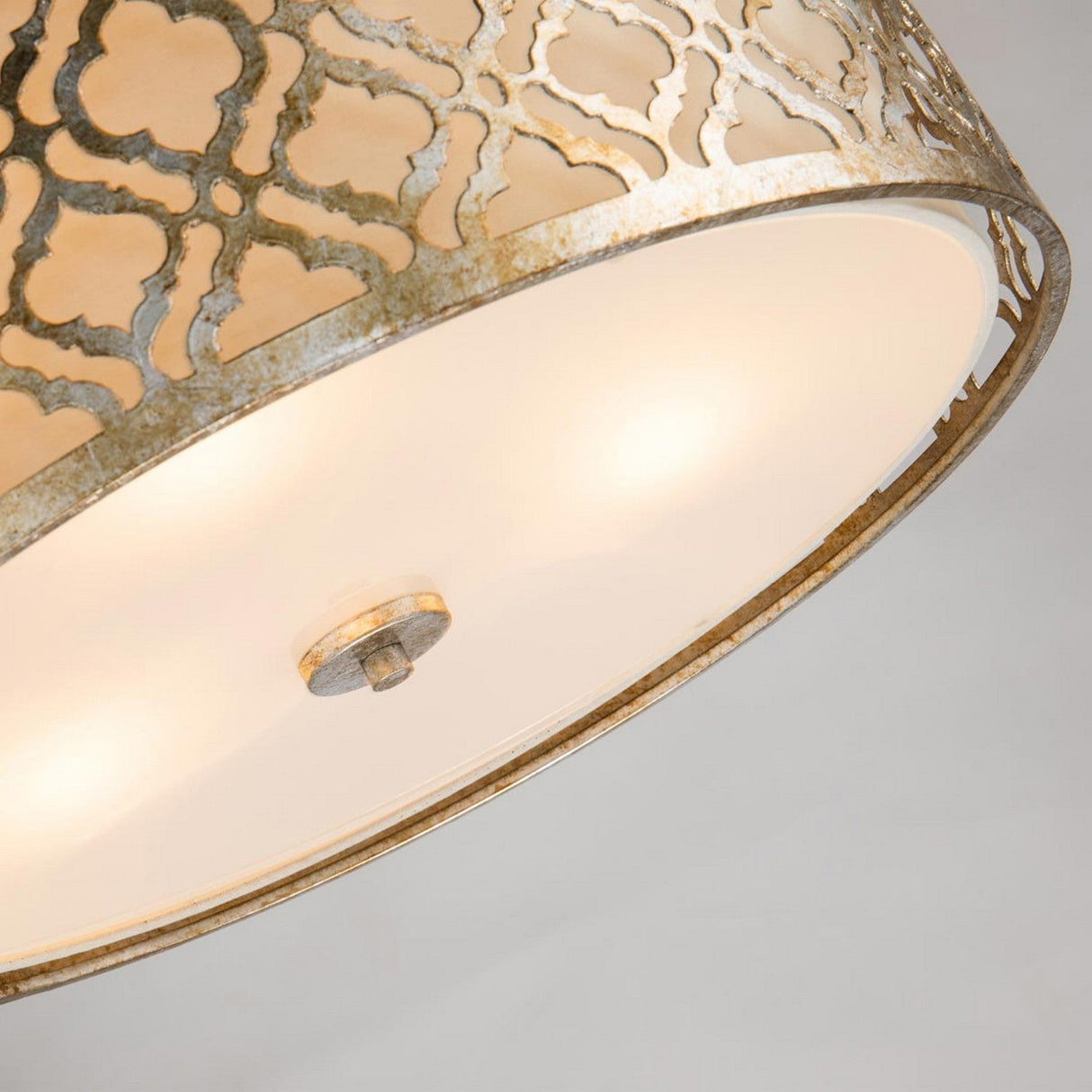 Take a close look at the Arabella 3 Light Duo-Mount Large Pendant/Semi-Flush, showcasing a stunning gold metal design with intricate cut-outs and an ivory shade. This ornate ceiling light fixture softly disperses white light, creating a warm glow. It's also compatible with retrofit LED lamps for enhanced modern efficiency.