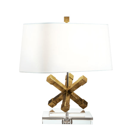 The Jackson Square 1 Light Table Lamp - Gold showcases a cream linen shade paired with a distinctive geometric star base in a striking gold finish. Its base is gracefully set atop a clear, rectangular block, infusing any space with modern sophistication.