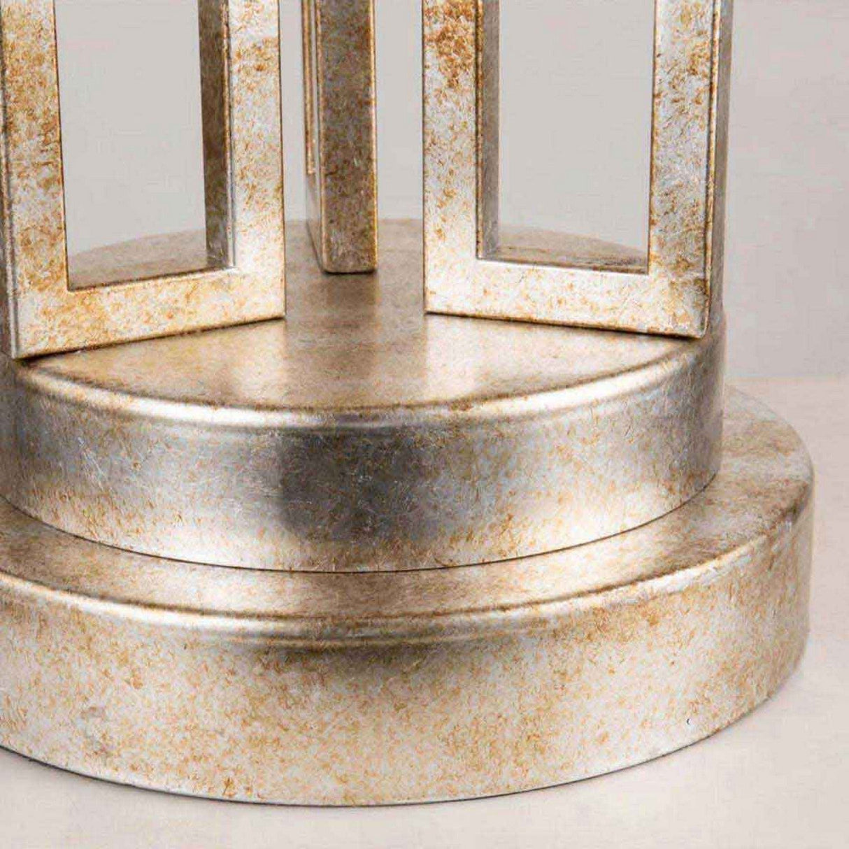 Capture the detail of a metallic, cylindrical form with a textured surface similar to brushed metal. It showcases two stacked circular bases and rectangular frames extending upwards, echoing the elegant design of the Lemuria 1 Light Table Lamp - Gold With Ivory Shade. The color presents a harmonious blend of silver and gold hues, imparting a luxurious finish.