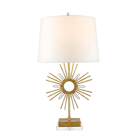 The Sun King 1 Light Table Lamp features a gold base with a sunburst design, complemented by lively golden and metallic accents. It is topped with an ivory, tapered lampshade and stands on a square, transparent platform adorned with elegant details.