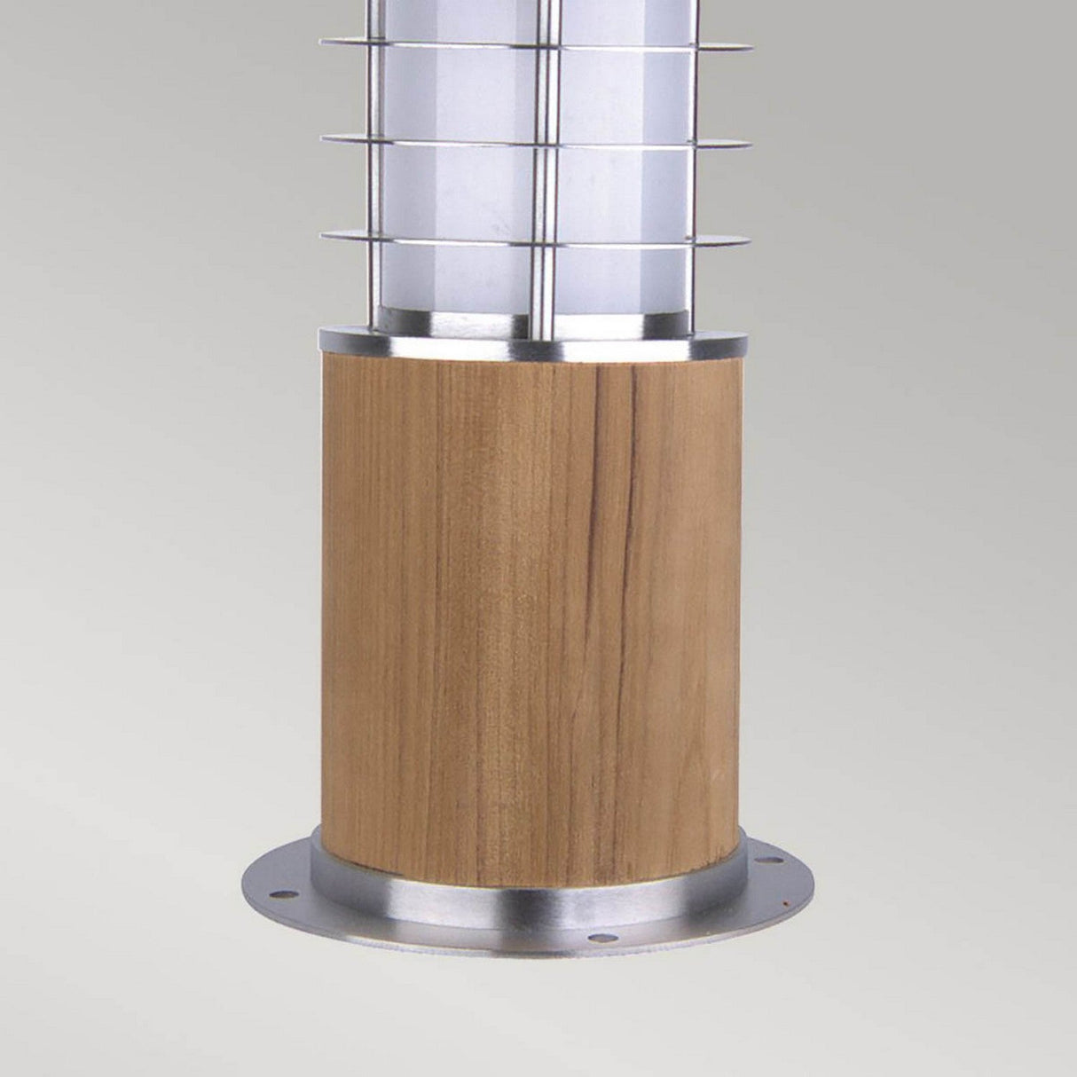 The Poole 1 Light Mini Bollard - Light Brown showcases a sleek cylindrical wooden base, enhanced by a metal grill crafted from Marine Grade 316 Stainless Steel, encasing a frosted glass light fixture. Perfect for garden or pathway lighting, this mini bollard design introduces a contemporary touch.