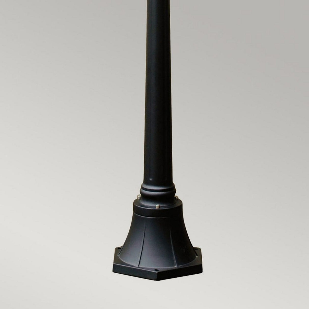 The Ledbury 1 Light Lamp Post - Black, expertly crafted from cast aluminium with a flared base, stands proudly against a plain gray background. This lamp post's cylindrical design includes a decorative tapered detail near the bottom, capturing the elegance of Heritage Lantern-style exterior lighting for enhanced visual appeal.