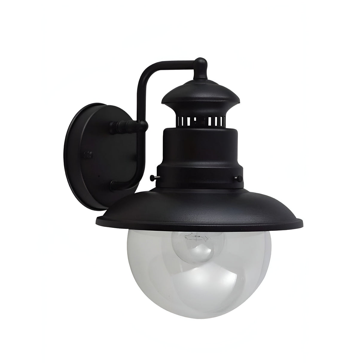 The Shipston 1 Light Outdoor Wall Lantern - Black is a timeless outdoor wall sconce with a round, see-through glass globe encasing the light bulb. Its sophisticated design features a smoothly curved arm attached to a circular wall mount, offering both aesthetic appeal and practical use.